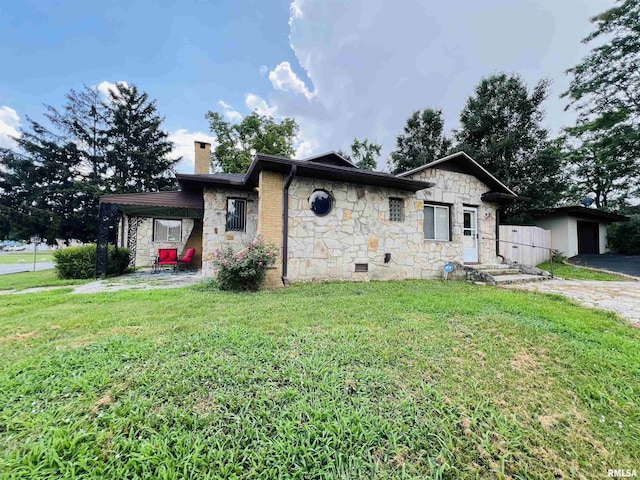 385 3rd St, Omaha, IL 62871 - view of front of home with stone siding, a chimney, a front yard, and a garage