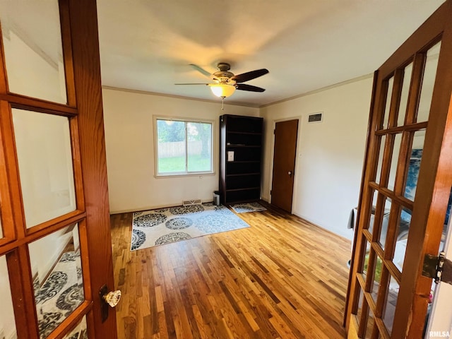 385 3rd St, Omaha, IL 62871 - foyer with light wood-type flooring, a ceiling fan, and ornamental molding