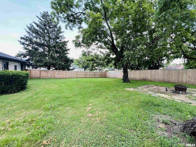385 3rd St, Omaha, IL 62871 - fenced backyard featuring an outdoor fire pit