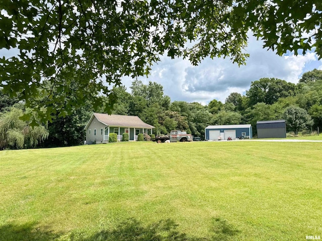 339 Spring St, Dongola, IL 62926 - view of green lawn with an outbuilding and a garage