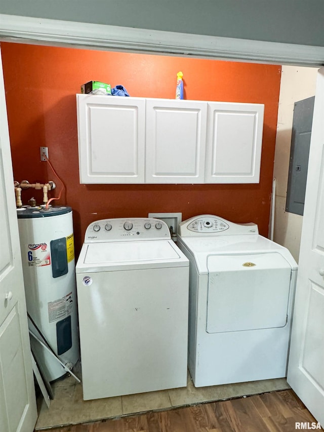 339 Spring St, Dongola, IL 62926 - washroom with electric water heater, cabinet space, electric panel, washer and clothes dryer, and wood finished floors