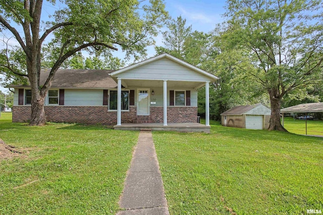 1130 W Webster St, Benton, IL 62812 - view of front of property with brick siding, a porch, a garage, a front lawn, and an outbuilding