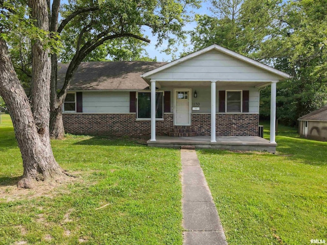 1130 W Webster St, Benton, IL 62812 - bungalow-style home with brick siding, covered porch, and a front yard