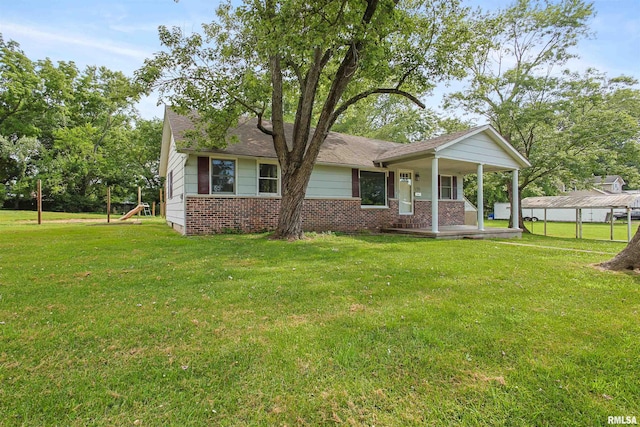 1130 W Webster St, Benton, IL 62812 - view of front facade featuring covered porch, a front yard, and brick siding