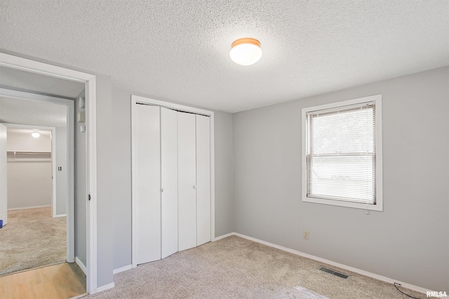 1130 W Webster St, Benton, IL 62812 - unfurnished bedroom featuring a textured ceiling, a closet, and carpet floors