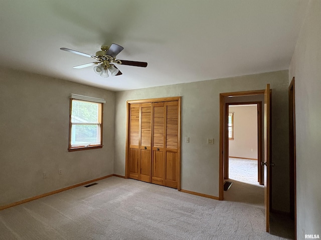 822 N 24th St, Murphysboro, IL 62966 - unfurnished bedroom featuring light colored carpet, a closet, and ceiling fan