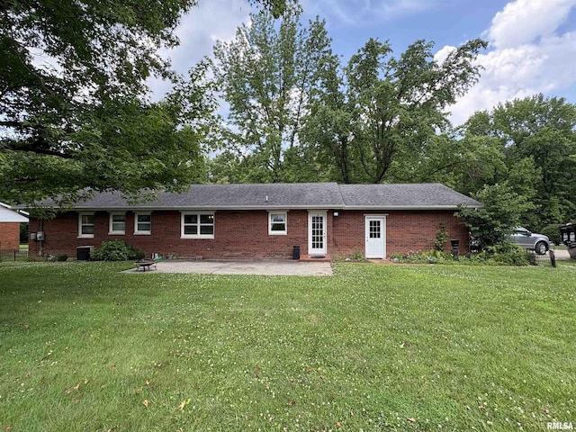822 N 24th St, Murphysboro, IL 62966 - back of house with brick siding, a patio area, and a lawn