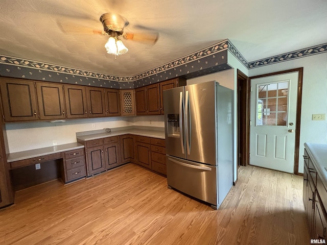 822 N 24th St, Murphysboro, IL 62966 - kitchen with stainless steel fridge with ice dispenser, light wood-style flooring, ceiling fan, light countertops, and wallpapered walls