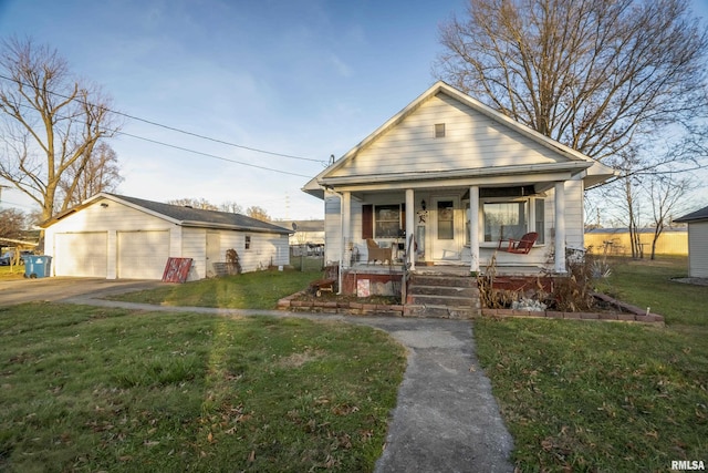 402 S Clay St, Sesser, IL 62884 - view of front facade with covered porch, an outbuilding, a detached garage, and a front yard
