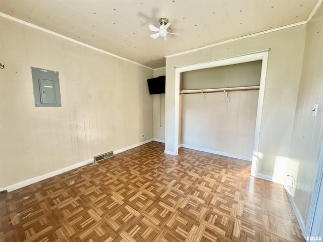402 S Clay St, Sesser, IL 62884 - unfurnished bedroom featuring electric panel, a closet, ornamental molding, and wood walls