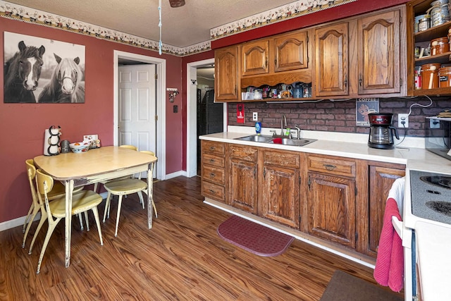 402 S Clay St, Sesser, IL 62884 - kitchen featuring open shelves, light countertops, white range with electric cooktop, brown cabinets, and dark wood-style floors
