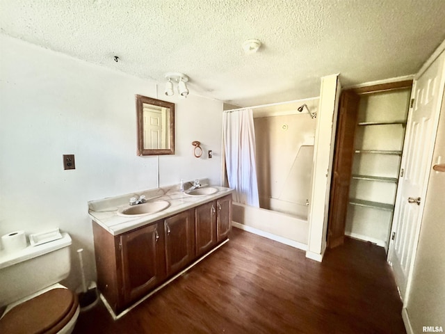 402 S Clay St, Sesser, IL 62884 - full bathroom featuring wood finished floors, a textured ceiling, shower / bath combo with shower curtain, and double vanity