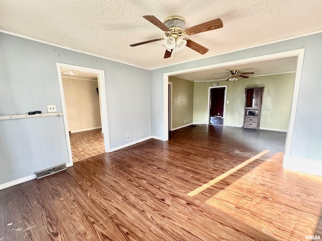 402 S Clay St, Sesser, IL 62884 - spare room featuring wood finished floors, a ceiling fan, a textured ceiling, and ornamental molding