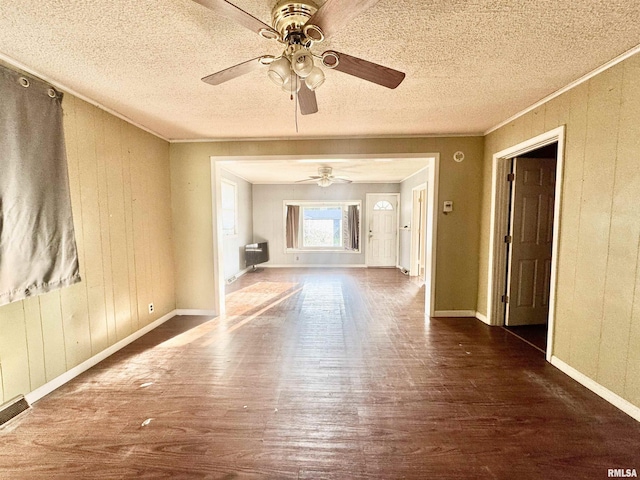 402 S Clay St, Sesser, IL 62884 - unfurnished living room featuring wood finished floors, ceiling fan, ornamental molding, a textured ceiling, and wooden walls