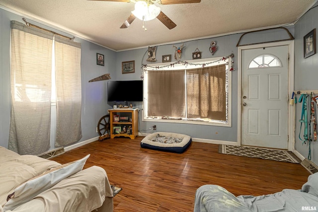 402 S Clay St, Sesser, IL 62884 - living area with ceiling fan, a textured ceiling, wood finished floors, and crown molding