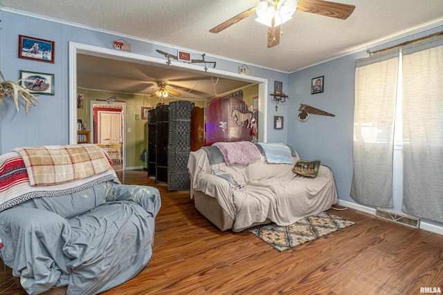 402 S Clay St, Sesser, IL 62884 - living room with a ceiling fan, crown molding, wood finished floors, and a textured ceiling