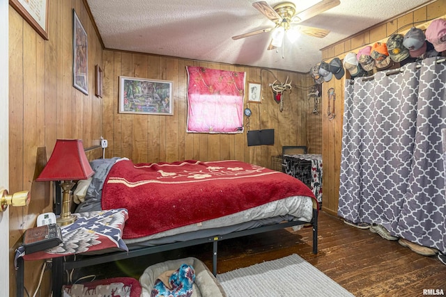 402 S Clay St, Sesser, IL 62884 - bedroom featuring hardwood / wood-style floors, a textured ceiling, wooden walls, and ceiling fan