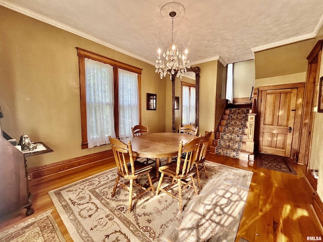 850 Joppa N Ave, Joppa, IL 62953 - dining area with stairs, wood finished floors, a chandelier, and crown molding