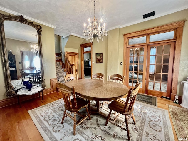 850 Joppa N Ave, Joppa, IL 62953 - dining space featuring a chandelier, hardwood / wood-style flooring, stairway, and ornamental molding