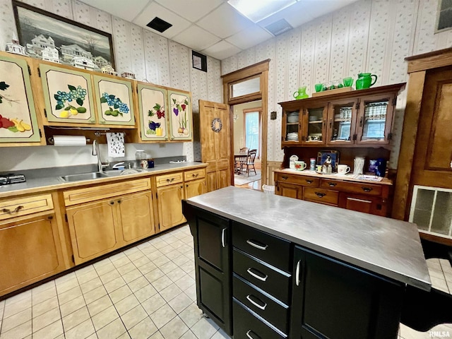 850 Joppa N Ave, Joppa, IL 62953 - kitchen with wallpapered walls, light countertops, dark cabinetry, light tile patterned floors, and a drop ceiling