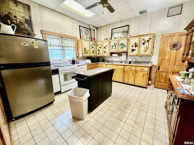 850 Joppa N Ave, Joppa, IL 62953 - kitchen featuring freestanding refrigerator, wallpapered walls, white gas range, light tile patterned floors, and ceiling fan