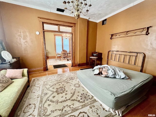 850 Joppa N Ave, Joppa, IL 62953 - bedroom with a chandelier, wood finished floors, and ornamental molding