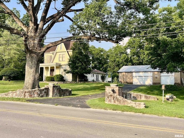 850 Joppa N Ave, Joppa, IL 62953 - view of front of house with a detached garage, a front lawn, and an outdoor structure
