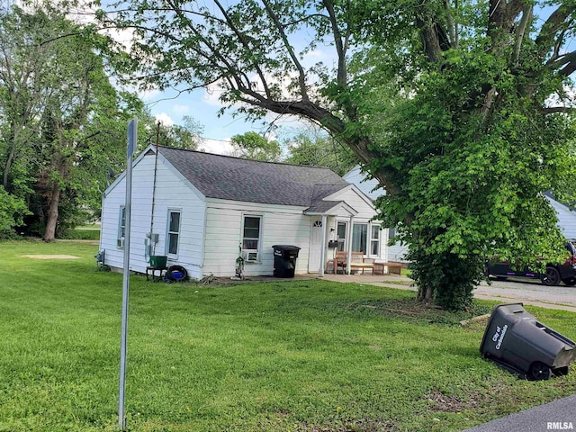 715 N Carico St, Carbondale, IL 62901 - view of front of property featuring a front lawn, a shingled roof, and a patio area