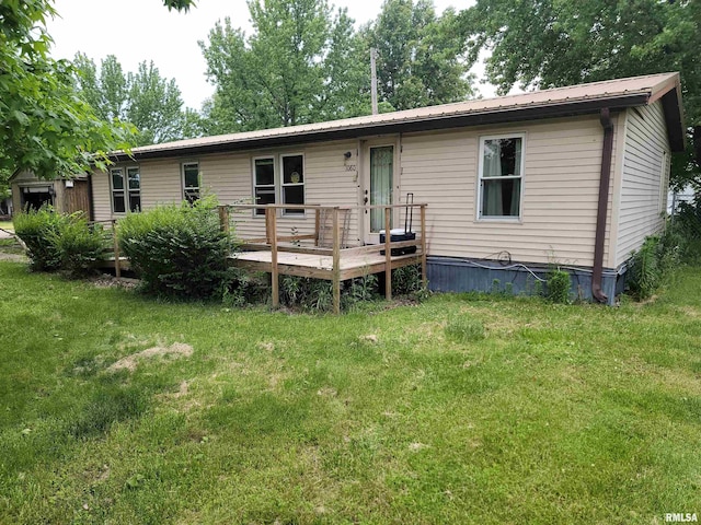 1060 W 5th St, Flora, IL 62839 - rear view of property featuring a deck, a yard, and a metal roof
