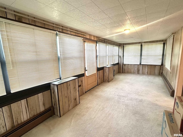 321 S Maple St, Centralia, IL 62801 - unfurnished sunroom featuring baseboard heating, wood walls, carpet, and healthy amount of natural light