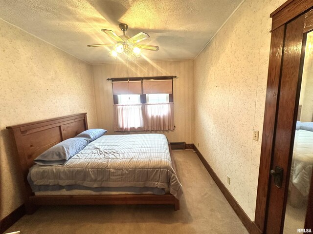 321 S Maple St, Centralia, IL 62801 - bedroom with a textured ceiling, carpet flooring, a baseboard heating unit, and ceiling fan
