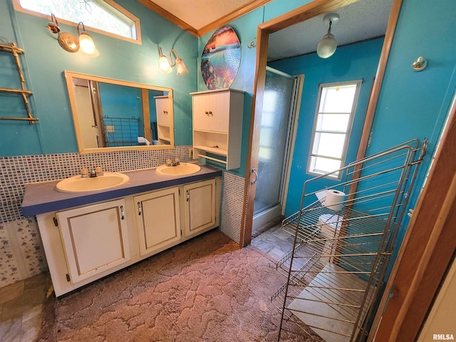 235 W 8th St, Flora, IL 62839 - full bathroom with a shower stall, double vanity, plenty of natural light, and tasteful backsplash