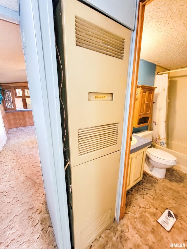 235 W 8th St, Flora, IL 62839 - bathroom with a heating unit, vanity, shower / tub combo, and a textured ceiling