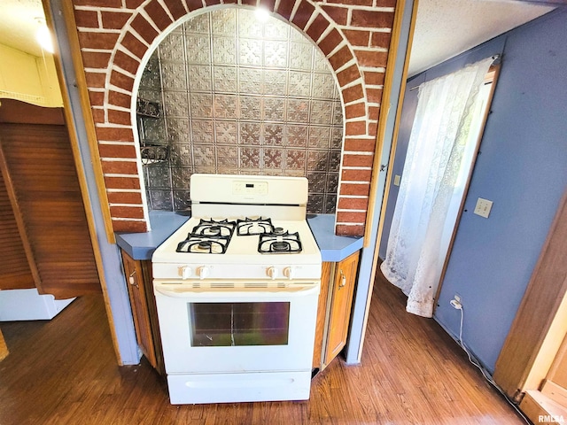 235 W 8th St, Flora, IL 62839 - kitchen featuring white gas range and wood finished floors