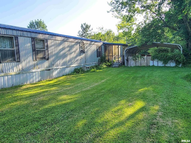 235 W 8th St, Flora, IL 62839 - view of grassy yard featuring a carport