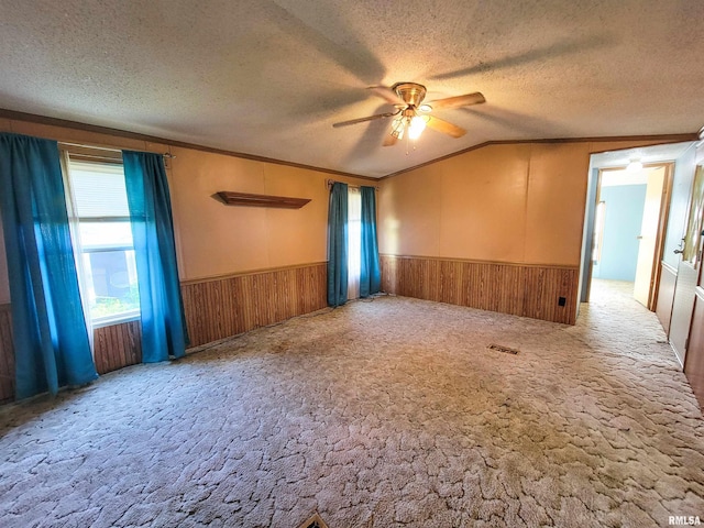 235 W 8th St, Flora, IL 62839 - carpeted empty room with a wainscoted wall, ceiling fan, crown molding, a textured ceiling, and lofted ceiling