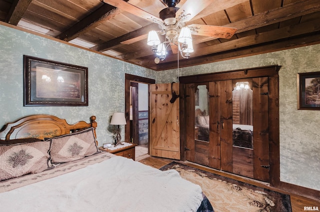 690 Ganntown Ln, Grantsburg, IL 62943 - bedroom with wood finished floors, wallpapered walls, and a wood ceiling with exposed beams