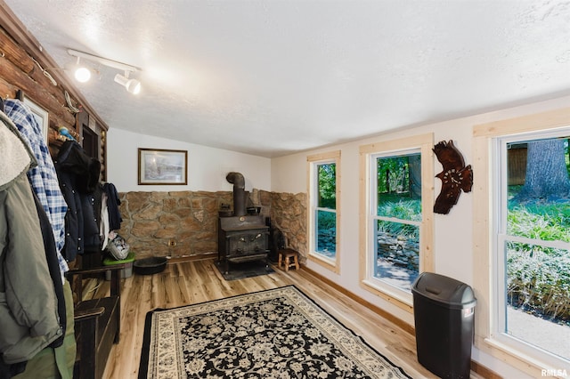 690 Ganntown Ln, Grantsburg, IL 62943 - sitting room with a wood stove, wood finished floors, a textured ceiling, and vaulted ceiling