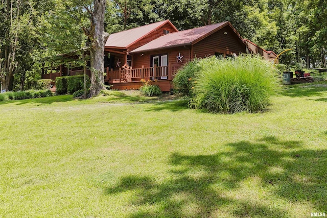 690 Ganntown Ln, Grantsburg, IL 62943 - view of side of home featuring a lawn, a deck, and a metal roof