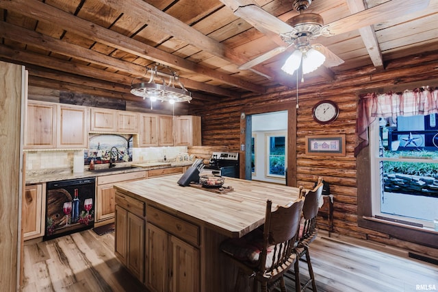 690 Ganntown Ln, Grantsburg, IL 62943 - kitchen with butcher block countertops, dishwasher, a wooden ceiling with exposed beams, light wood-style flooring, and a breakfast bar area