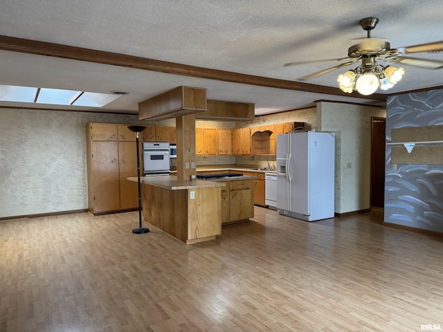 3100 Ava Rd, Murphysboro, IL 62994 - kitchen featuring white appliances, light wood finished floors, a kitchen island, beam ceiling, and a ceiling fan