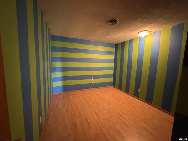3100 Ava Rd, Murphysboro, IL 62994 - empty room featuring wallpapered walls, wood finished floors, and a textured ceiling