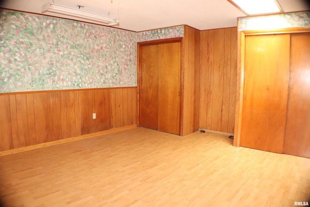 3100 Ava Rd, Murphysboro, IL 62994 - unfurnished bedroom featuring a wainscoted wall, wood finished floors, wallpapered walls, and wooden walls