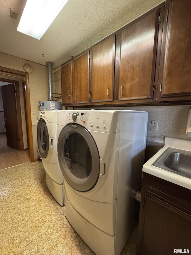 3100 Ava Rd, Murphysboro, IL 62994 - washroom featuring washing machine and dryer, cabinet space, light floors, and water heater
