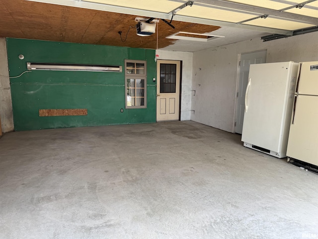 3100 Ava Rd, Murphysboro, IL 62994 - garage featuring freestanding refrigerator and a garage door opener