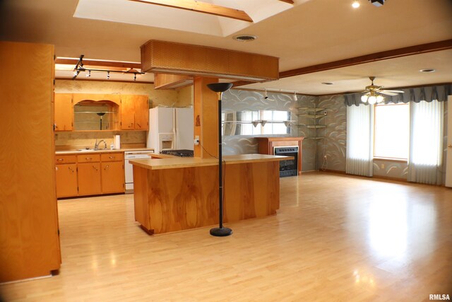 3100 Ava Rd, Murphysboro, IL 62994 - kitchen featuring white appliances, light countertops, light wood finished floors, a glass covered fireplace, and open floor plan