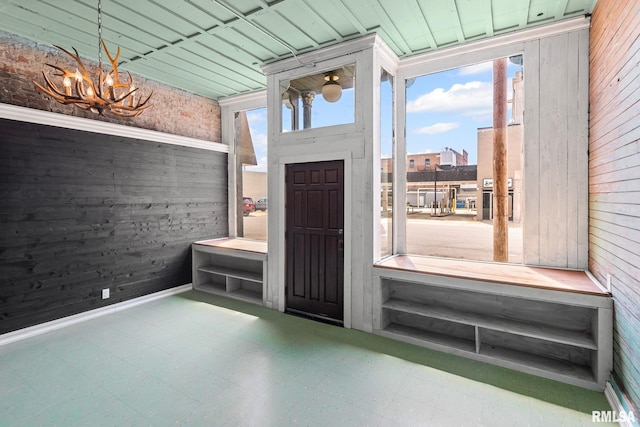 6 S Division St, Duquoin, IL 62832 - entryway with tile patterned floors, wood walls, and a chandelier