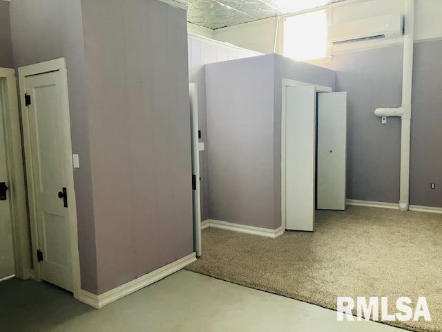 6 S Division St, Duquoin, IL 62832 - basement with a wall mounted air conditioner and carpet flooring