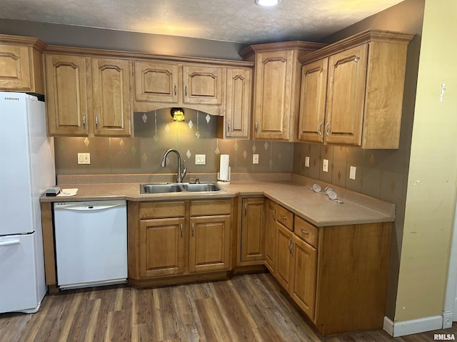 104 Mcneil St, Energy, IL 62933 - kitchen featuring white appliances, dark wood-style flooring, light countertops, and brown cabinetry