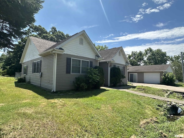 104 Mcneil St, Energy, IL 62933 - view of front of property with driveway, an outbuilding, a front lawn, and roof with shingles